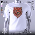 Футболка ведмідь білого кольору, зображена з фронтального ракурсу на манекені, фон світло-сірий, принт у вигляді ведмедя з червоними та коричневими деталями, оформлений у стилі геометричних візерунків.