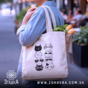 Шопер котики в окулярах — деталі тканини, ручок і швів крупним планом.