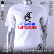 Футболка чарівник автомеханік, біла, зображена на манекені, фон нейтральний, принт містить чорний магічний капелюх з зірками та інструменти, текст червоний і синій.