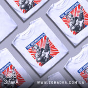 Футболка час прокинутись. Біла футболка на манекені, з принтом, що зображує чоловіка з гітарою на червоному фоні з променями. Принт містить текст "ЧАС ПРОКИНУТИСЬ" у верхній частині.