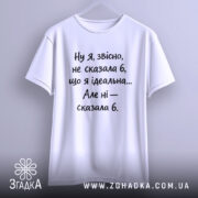 Футболка я не ідеальна. Біла футболка на вішалці, з коротким рукавом, на світлому фоні. Принт чорного кольору з текстом, що говорить про ідеальність.