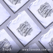 Футболка красива розумна, білого кольору, зображена на моделі в ракурсі спереду, фон світло-фіолетовий, принт чорного кольору з написом "КРАСИВА РОЗУМНА, але кукуха підводить" в декоративному стилі.