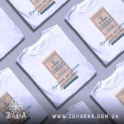 Футболка квиток, біла, на моделі, фон ніжно-фіолетовий, принт у вигляді квитка з текстом і гербом України.