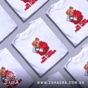 Футболка не роби мені нєрви. Біла футболка з коротким рукавом, зображення ведмедя в червоному капюшоні з сокирою на фоні світло-фіолетового кольору, текст "НЕ РОБИ МЕНІ НЕРВИ!" під малюнком.