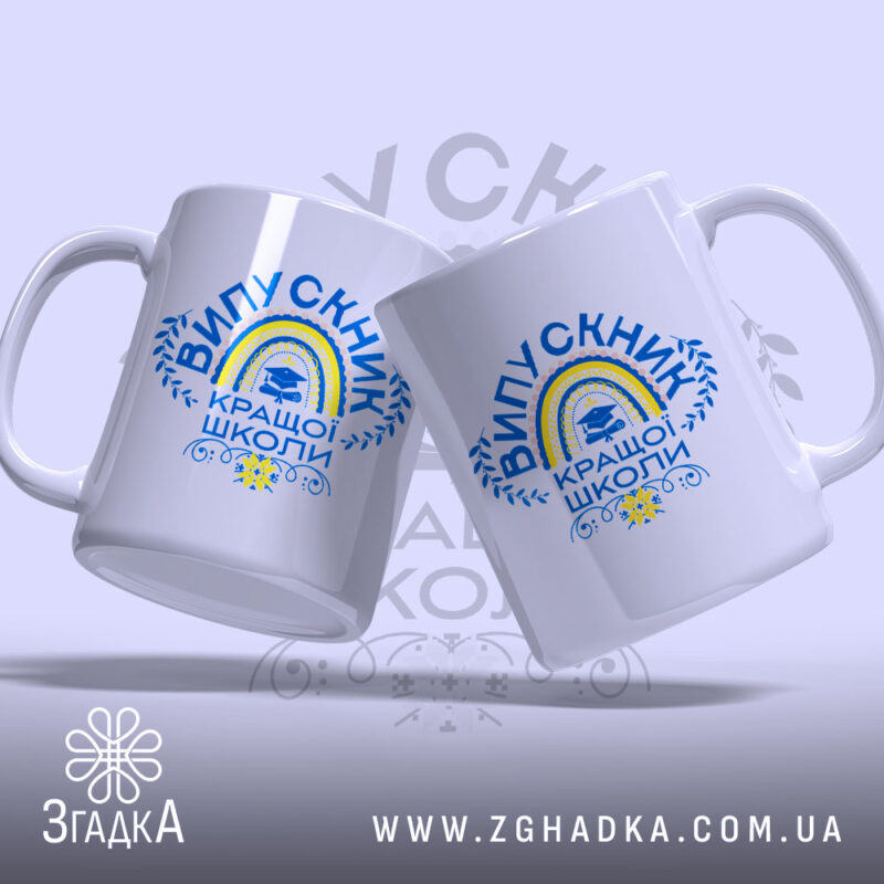 Чашка випускник кращої школи, зображена з двох боків, на світлому фоні, з яскравим принтом 'ВИПУСКНИК КРАЩОЇ ШКОЛИ', ручки чашок видно чітко, краї рівні, глянцева поверхня.
