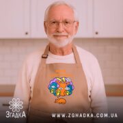 Фартух мрій по-крупному з котиком, бежевий, на літньому чоловікові в кухні, бренд.