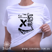 Футболка будь щасливим, біла, на плоскій поверхні, з принтом чорного кольору, напис 'just' та усмішка, тег на зеленій стрічці.