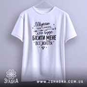 Футболка шукаю того самого, біла, підвішена на вішалці, фон світло-сірий, принт чорний з текстом, рукава короткі, простий крій.