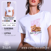 Футболка ведмедик і удача, біла, зображена на моделі, фон світло-фіолетовий, принт з ведмедиком у сонцезахисних окулярах та написами 'Lucky You' і 'Best of Luck'.