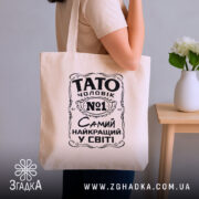 Шопер Тато найкращий чоловік, бежевий, на плечі, фон з кімнатою, бренд Згадка.