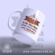 Чашка я як пасочка але тримаюсь, біла з принтом торта, ракурс зліва,.