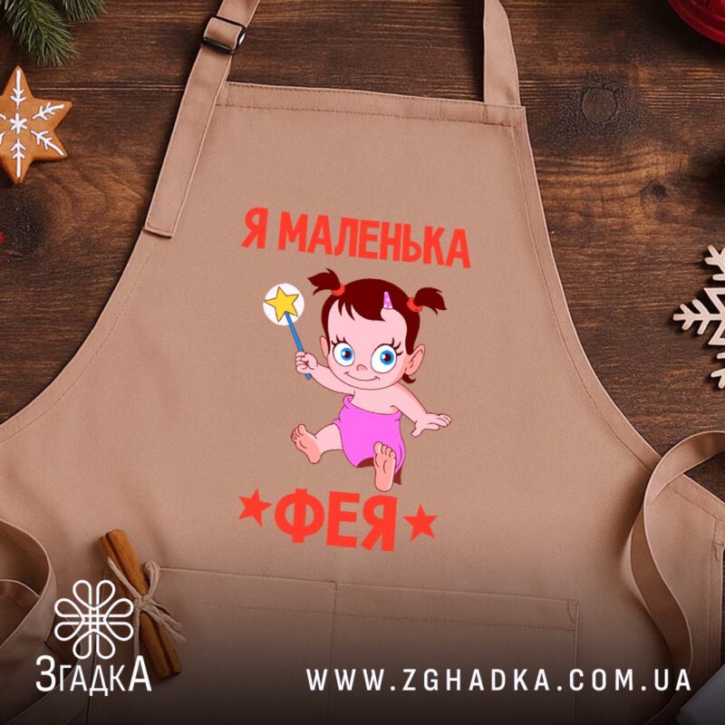 Фартух я маленька фея, бежевий, на дерев'яному фоні, бренд Згадка.
