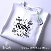 Футболка пофіг на все, складена, біла, з етикеткою, принт на тканині, бренд.