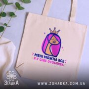 Шопер мені можна все, бежевий на столі, зелена рослина на фоні, бренд.