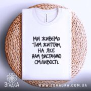 Футболка: біла, на кошику, текст на грудях.